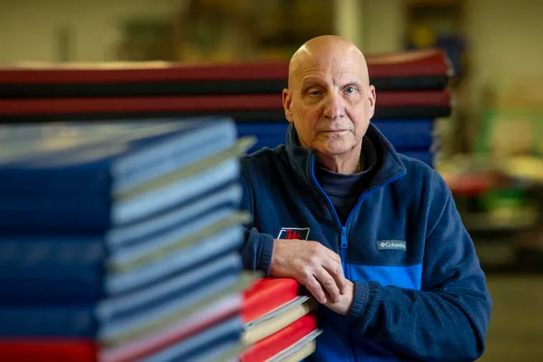 Bob Mancino, owner of Mancino Manufacturing in Lansdale, on the shop floor with an assortment of gym mats handsewn by staff he has slashed with the closure of schools and gyms due to the coronavirus pandemic.