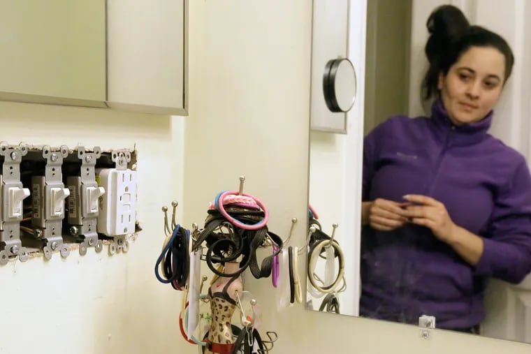 Roxana Stuart looks at the open electrical switches (they came that way) in the master bathroom of her home, a newly constructed townhouse on Berkely St. in Camden's Lanning Square section on Dec. 29.