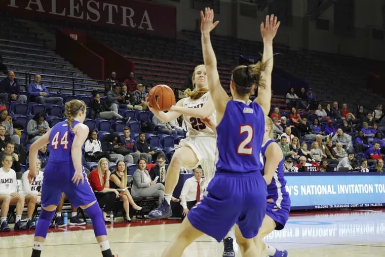 Penn's Ashley Russell drives for two of her game-high 18 points in the Quakers' win over American at the Palestra in the first round of the women's NIT.