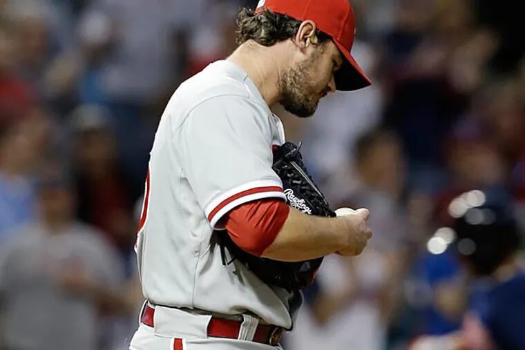 Philadelphia Phillies relief pitcher Chad Durbin, left, waits for Cleveland Indians' Ryan Raburn to run the bases after Raburn hit a two-run home run in the fifth inning of a baseball game, Tuesday, April 30, 2013, in Cleveland. (AP Photo/Tony Dejak)