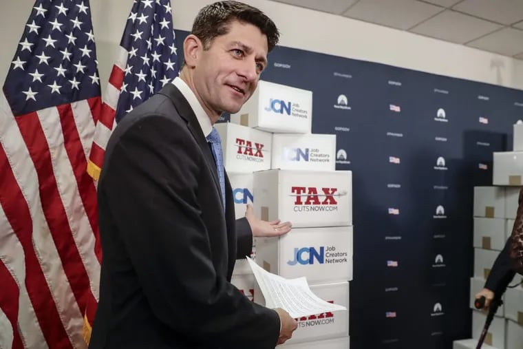 Speaker of the House Paul Ryan (R., Wis.) points to boxes of petitions supporting the Republican tax reform bill that is set for a vote later this week as he arrives for a news conference on Capitol Hill in Washington earlier this month.