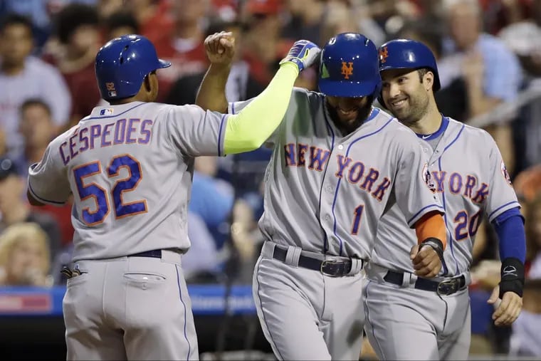 Mets outfielder Yoenis Cespedes,(left) Amed Rosario (center) and Neil Walker celebrate after Cespedes’ three-run home run in the third inning of the Phillies 7-6 loss to the Mets on Friday. Rosario hit the go-ahead run in the ninth.