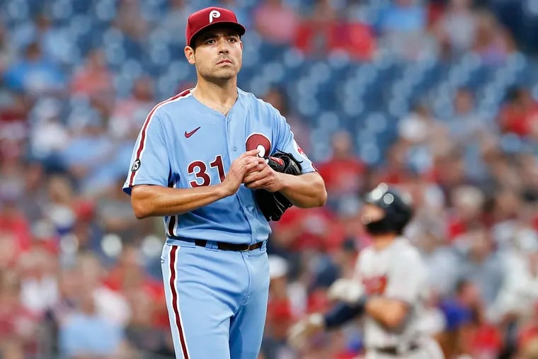 Phillies pitcher Matt Moore rubs a new ball after giving up a third-inning grand slam to the Braves' Dansby Swanson in Thursday night's 7-2 loss at Citizens Bank Park.