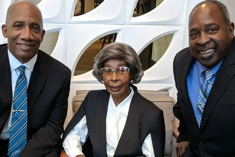 Mrs. Delk sits between her sons, Ronald Jackson (left) and Maurice Walls.