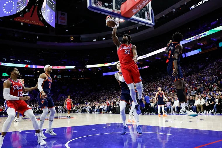 Sixers center Joel Embiid dunks past New York Knicks forward OG Anunoby during the first quarter of Game 4
