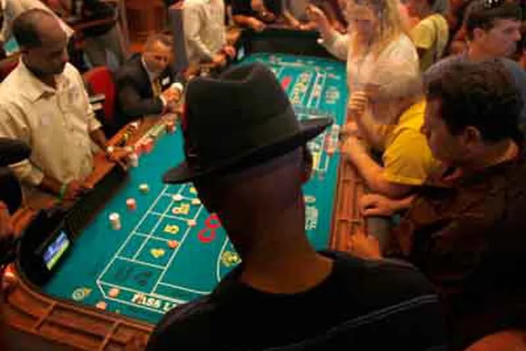 Customers gather around one of the craps table inside SugarHouse Casino. The casino opened in Philadelphia on September 23, 2010. ( David Maialetti / Staff Photographer )