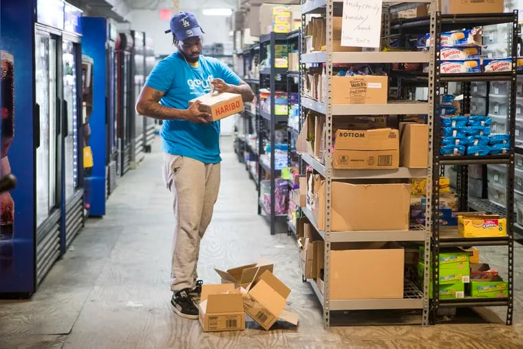 Wendell Moore stocks candy in Gopuff's expanded warehouse that opened last summer.