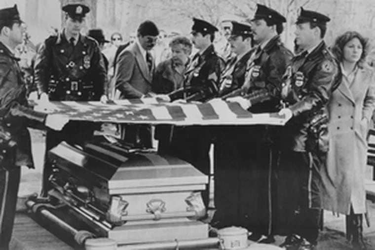 At Daniel Faulkner&#0039;s funeral in December 1981, police officers serving as pallbearers lift a U.S. flag from the slain policeman&#0039;s casket. Maureen Faulkner (far right) has spent 26 years seeking closure in the courts in the death of her husband.