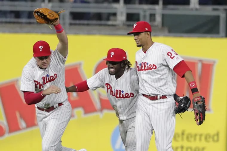 Rhys Hoskins (left), Odubel Herrera and Aaron Altherr celebrate the Phillies’ win over the Diamondbacks Wednesday.