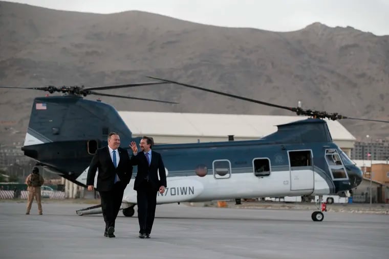 Secretary of State Mike Pompeo (left) walks from a helicopter with U.S. Ambassador to Afghanistan John Bass on Tuesday, one day before two U.S. soldiers were killed in Afghanistan.