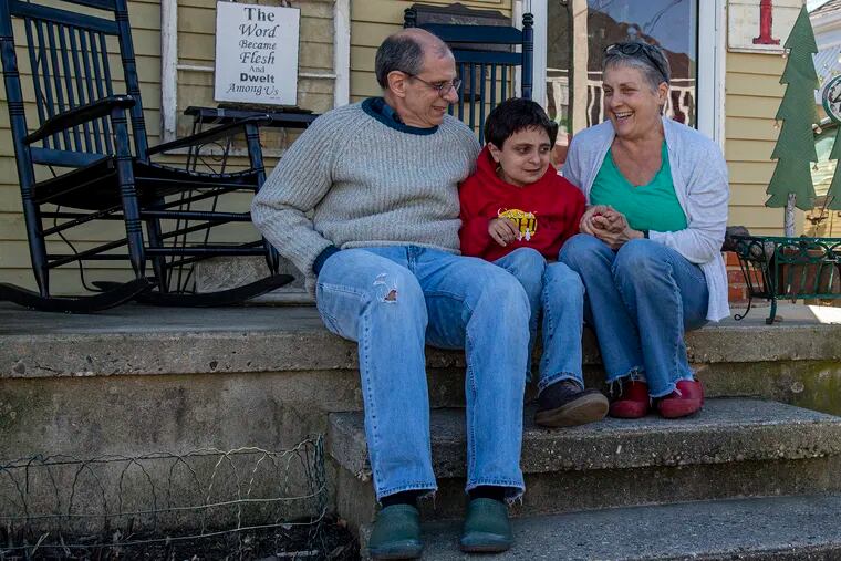 The DeFilippo family, Rick, (dad) Laura, (mom) and son  Luke, are photographed on the front steps of their home in Audubon, N.J.  Thursday, December 10, 2020. The DeFilippo family need to do renovations to their home to adjust to son Luke's disabled as his parents have also gotten older. Their Audubon neighbors have help to raise money under the Room for Luke campaign.