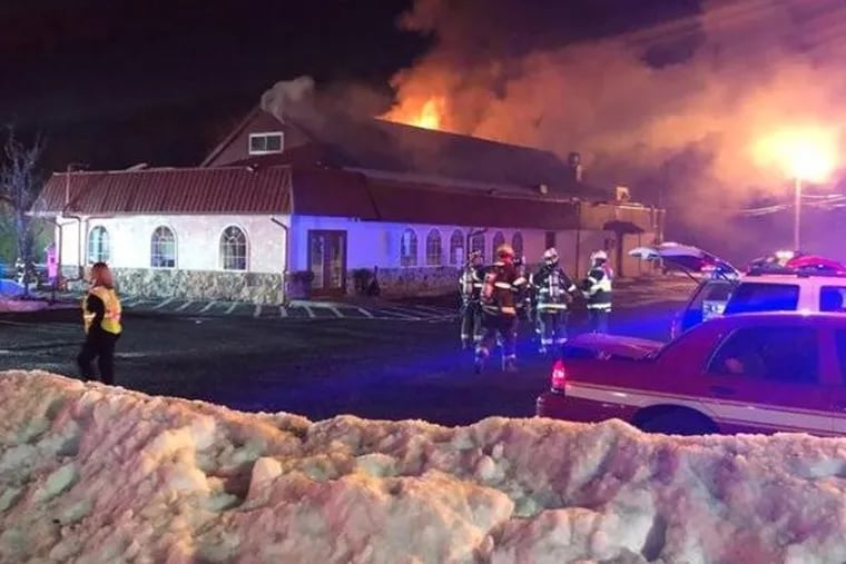 Fire burns through the roof of the the Country Town Diner.