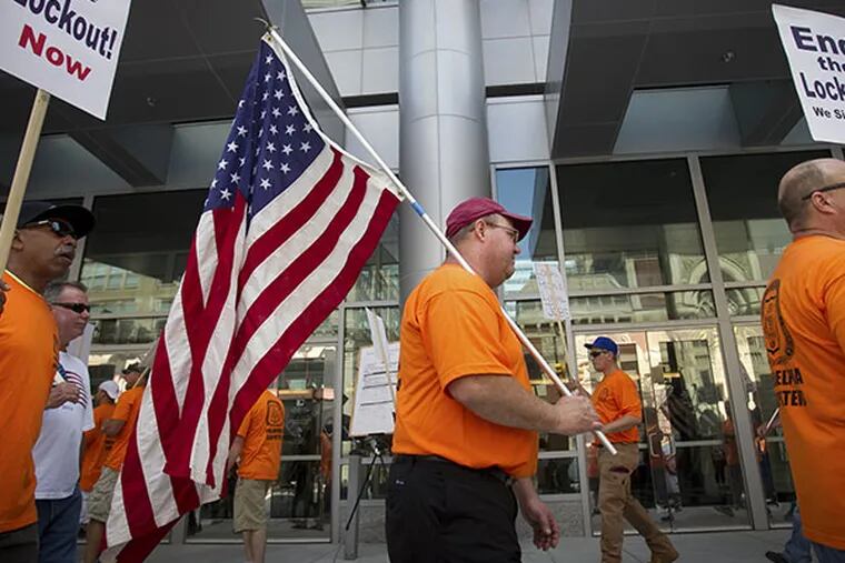 Members of the Metropolitan Regional Council of Carpenters hold a protest rally outside the Pennsylvania Convention Center protest at the entrance at N. Broad St. at Arch on Friday morning July 11, 2014. ( ALEJANDRO A. ALVAREZ / STAFF PHOTOGRAPHER )