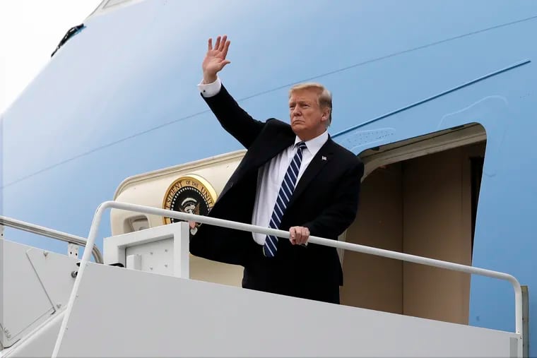 President Donald Trump waves as he boards Air Force One after a summit with North Korean leader Kim Jong Un, Thursday, Feb. 28, 2019, in Hanoi.