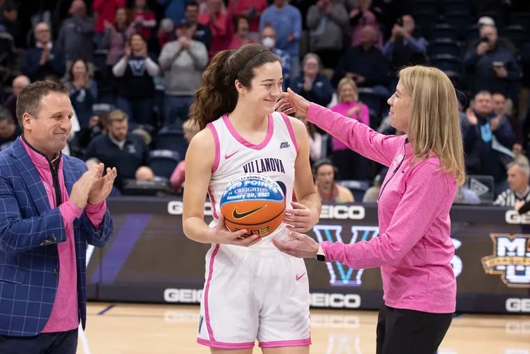 Maddy Siegrist (center) of Villanova was honored before the game against Marquette on Feb. 1 for breaking the school scoring record for both men and women at the Finneran Pavilion. On Saturday, Siegrist passed the Villanova single-game record (45), and the Big East single-game record (44) and became the Big East all-time leading scorer with 1,547 career points in conference play.