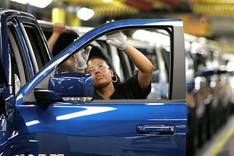 Yolanda Germany checks the door molding on Chrysler's new 2009 Dodge Ram pickup being assembled at the Warren Truck Plant in Warren, Mich. (AP Photo/Carlos Osorio)