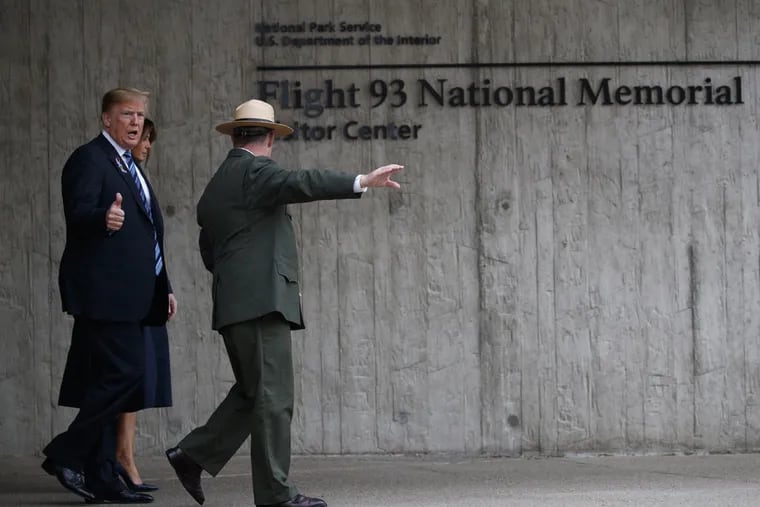 President Donald Trump and first lady Melania Trump walk along the September 11th Flight 93 memorial, Tuesday, Sept. 11, 2018, in Shanksville, Pa.