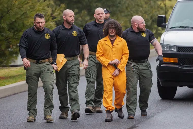 Danilo Cavalcante, escorted by officers with the Pennsylvania Department of Corrections, arrives for his preliminary hearing Friday at magisterial district court in Kennett Square. Cavalcante was held over on all charges, including burglary and escape, and will face arraignment in Chester County Court in the coming weeks.
