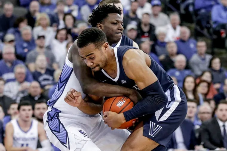 Villanova's Phil Booth and Creighton's Kaleb Joseph struggle for the ball during the second half of the Wildcats' 90-78 win on Sunday in Omaha, Neb.