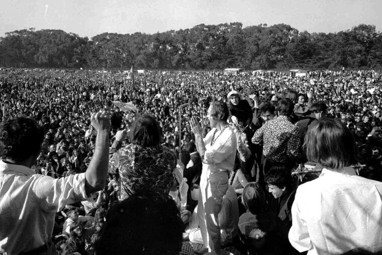 Timothy Leary, center, leads thousands in a song at the “Human Be-In” On the Golden Gate Park Polo Fields in San Francisco in 1967.
