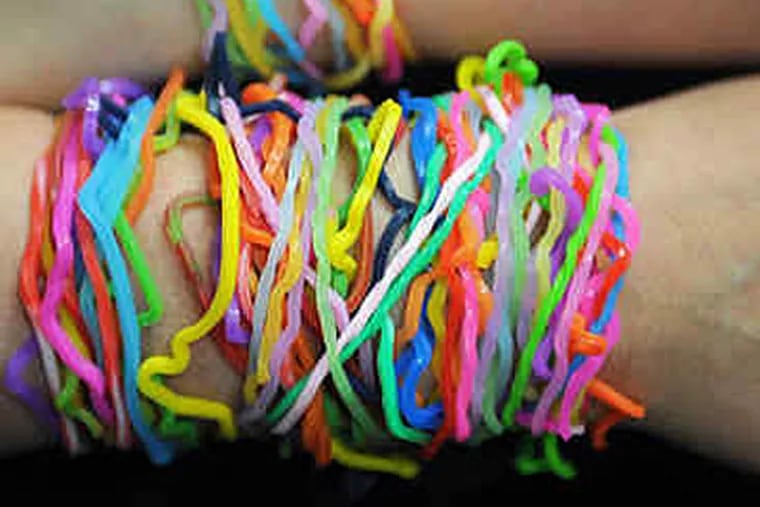 Josh Joffe, 10, has lots of bandz of different shapes and colors. Boys and girls love them, and wear them as bracelets. (Sharon Gekokski-Kimmel / Staff)