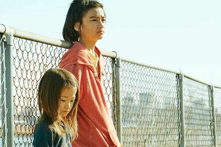 This image released by Magnolia Pictures shows Sasaki Miyu, left, and Jyo Kairi in a scene from "Shoplifters." (Magnolia Pictures via AP)