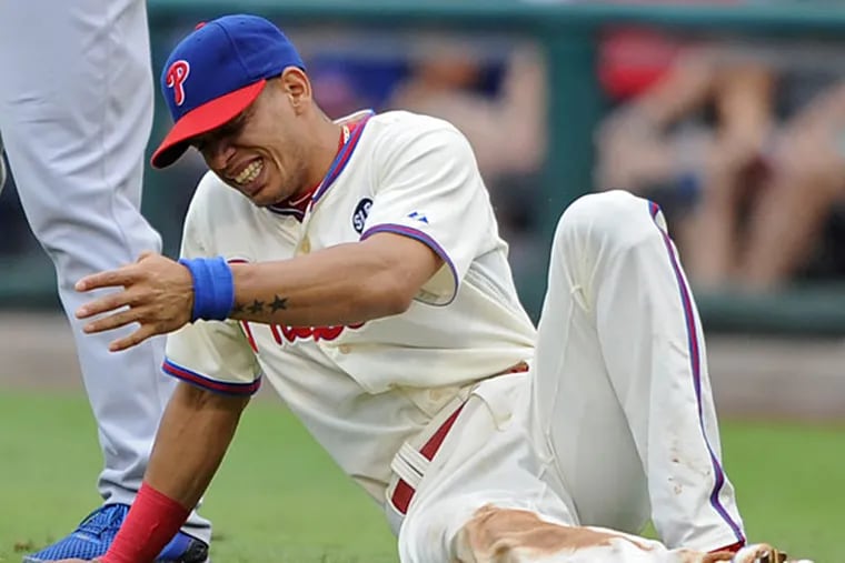 Phillies second baseman Cesar Hernandez grimaces after dislocating his left thumb.