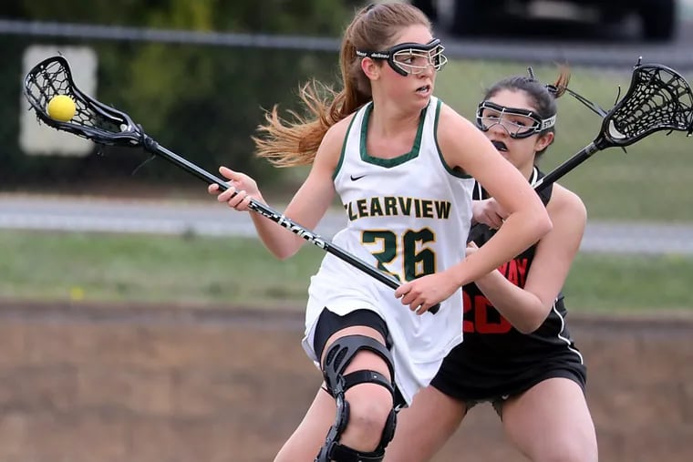 Girls Lacrosse game Kingsway at Clearview — .Clearview HS #26 Dani Paterno is running with a ball while Kingsway HS #20 Sam Volpe is trying to stop at first Half Clearview HS won 19 to 6 over Kingsway HS.