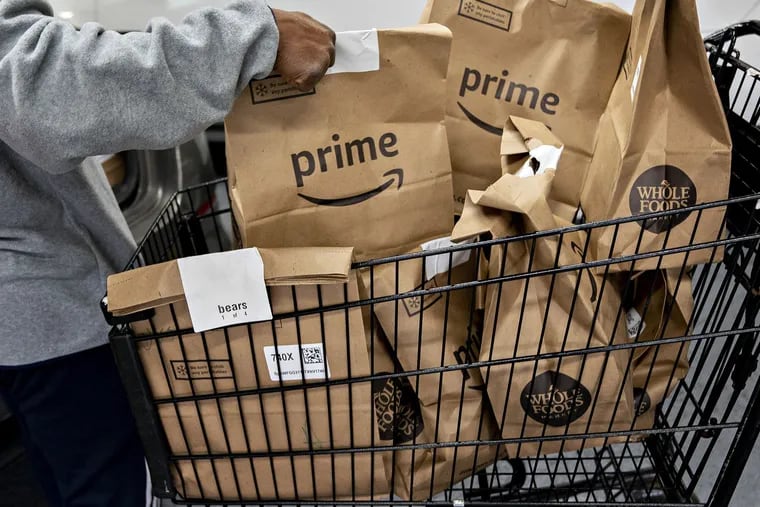 Amazon Prime grocery bags ready for delivery outside a Whole Foods in Washington, D.C., in March 2020.