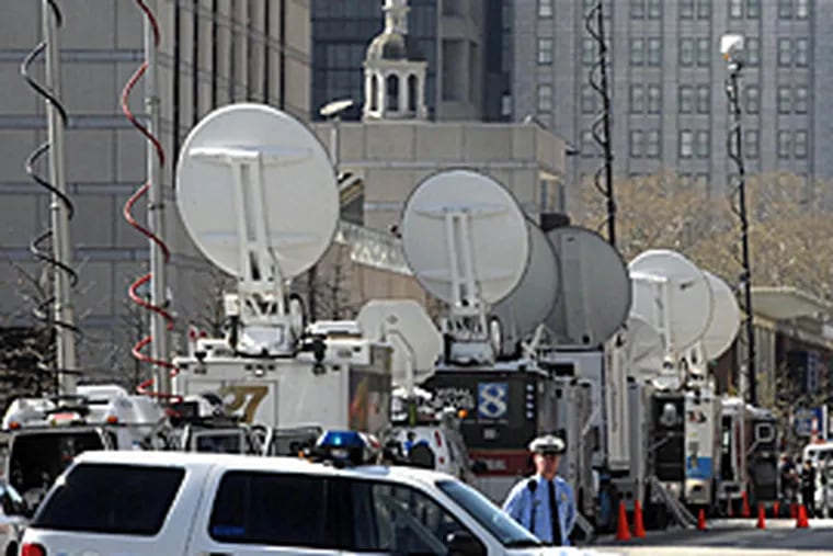 Satellite trucks line street as Philadelphia Police have closed a portion of Sixth Street near the National Constitution Center in preparation for tonight's Democratic primary debate. (Tom Gralish / Inquirer)