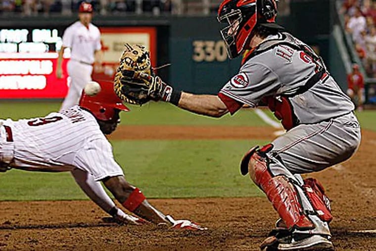 Domonic Brown slides home safely on a Jimmy Rollins sacrifice fly in the eighth inning. (Yong Kim/Staff Photographer)