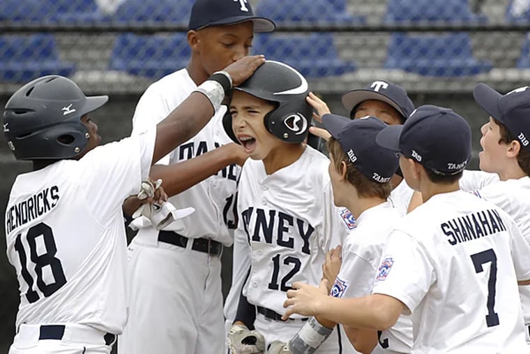 Taney's Jared Sprague-Lott is mobbed by teammates after his two-run
hone run during a regional tournament in Bristol, Conn., on Sunday,
Aug. 3, 2014. (Ron Cortes/Staff Photographer)
