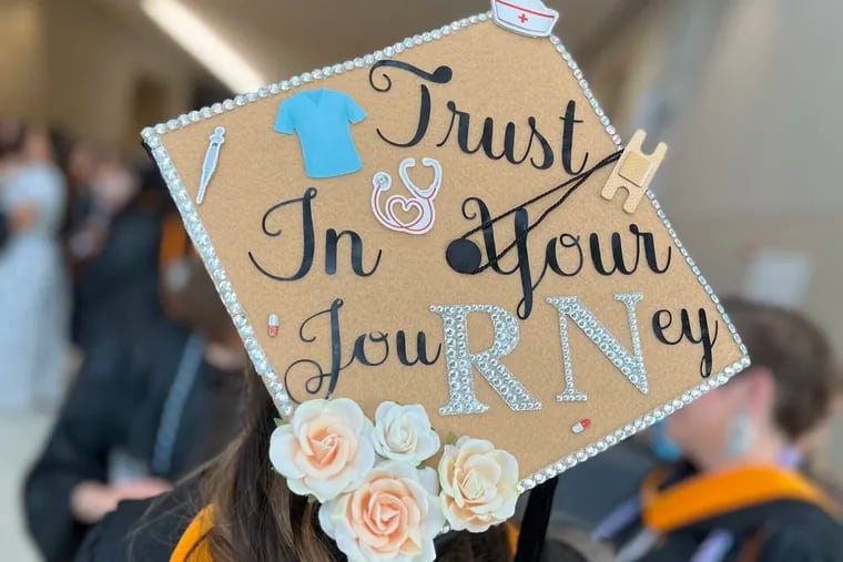A student wears a graduation cap with the letters "RN" highlighted, a reference to the nursing license, at Thomas Jefferson University's 2023 commencement.