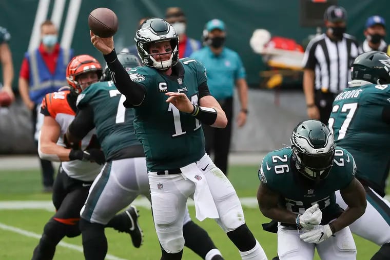 Eagles quarterback Carson Wentz throws a short pass against the Bengals on Sept. 27. Running back Mikes Sanders is on the right.
