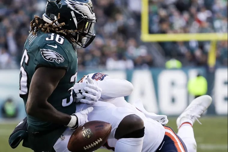 Eagles running back Jay Ajayi fumbles the football against Chicago Bears cornerback Cre'von LeBlanc and Kyle Fuller in the fourth-quarter on Sunday, November 26, 2017 in Philadelphia. Ajayi fumbled the football on the play and was recovered by the Eagles for a touchdown. YONG KIM / Staff Photographer