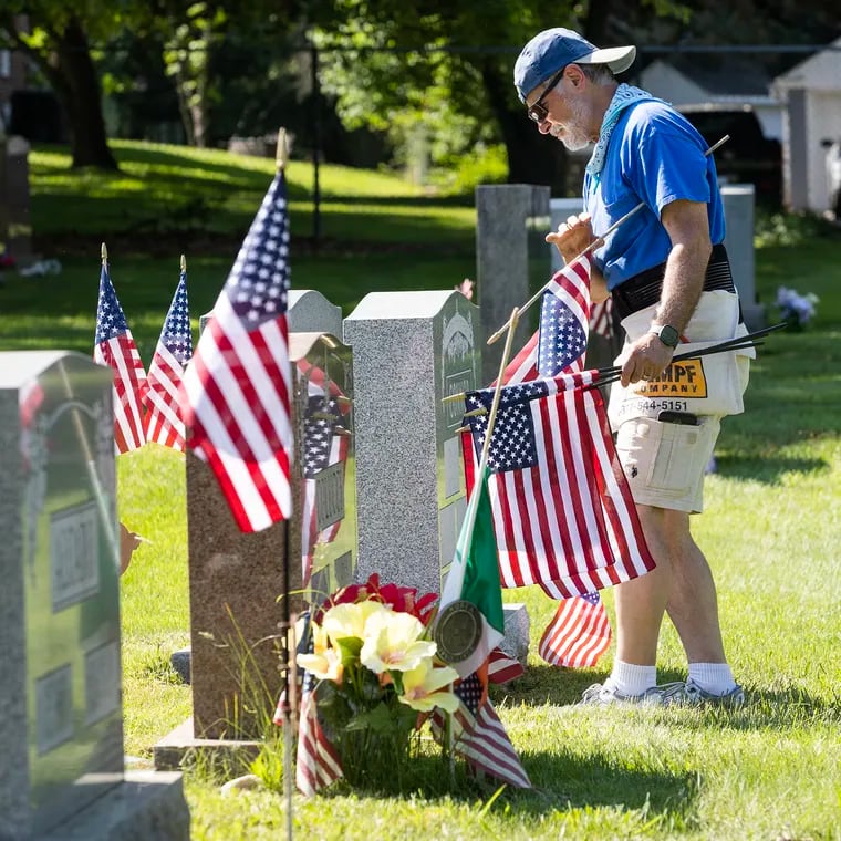 Ken Rucci, Sr.,70, of Westbrook Park, started in 2004 placing flags on the grave of his father, Paul Rucci, a World War II veteran., and a few other relatives.  It helped him deal with the loss of his father who had passed away in the fall of 2003.  He now places approximately 500 flags on the graves of veterans at Saints Peter  and Paul Cemetery in Springfield, Delaware County.  He is shown on May 24, 2024, the first day of a two day process