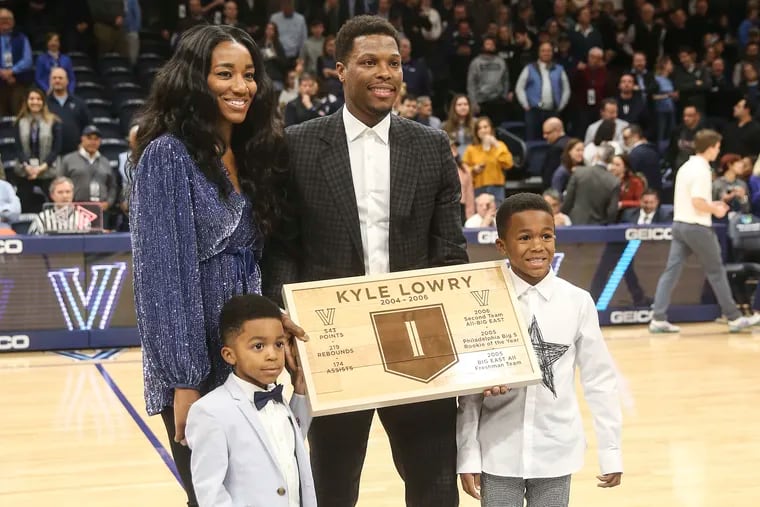 The Toronto Raptors' Kyle Lowry, former Villanova player ,with his wife, Ayahna, and his sons Karter, 6 and Kameron, 4 during a ceremony honoring him during halftime of the Villanova-St. John's  game.