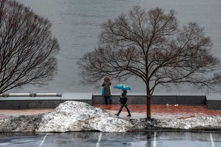Leftover snow piles at the end of last winter linger at Penn's Landing. The first flakes of the 2021-22 season landed in the region on Tuesday.