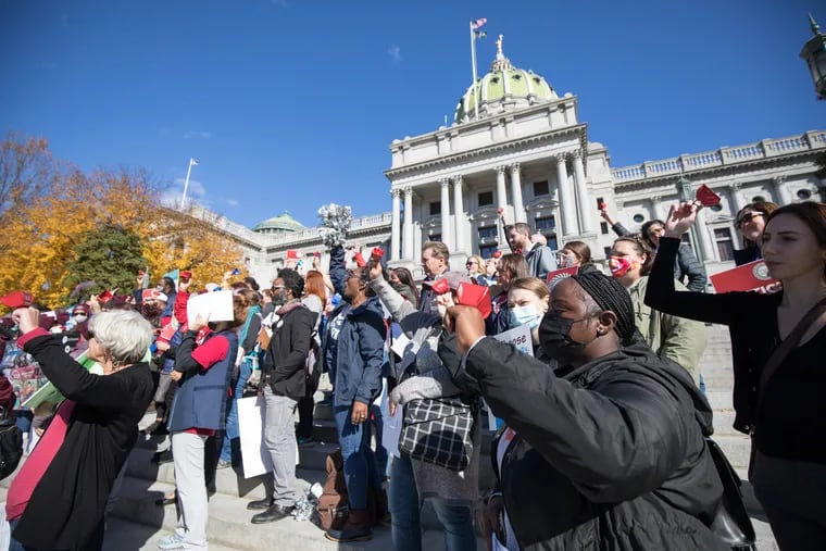 Supporters of changing Pennsylvania's school funding rally on the steps of the Capitol in Harrisburg on the first day of a historical trial challenging public education funding as inadequate and highlighting disparities between wealthy and poor districts.