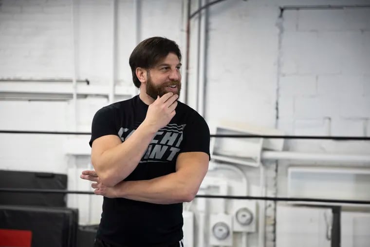 Drew Gulak talks with a reporter at CatchPoint Wrestling School in Philadelphia on Wednesday. Gulak is a WWE wrestler from Fox Chase.