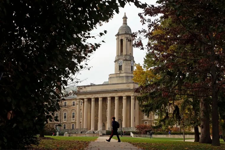 In this Nov. 9, 2017 file photo people walk by Old Main on the Penn State University main campus in State College, Pa. Only a few weeks, or maybe even days, remain until college campuses reopen. But not every student who starts college, finishes. In Philadelphia, there are 176,000 people who didn't finish their degrees.  (AP Photo/Gene J. Puskar, File)