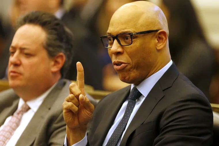 Superintendent William Hite (right) gestures as he sits next to Uri Monson, district chief financial officer, during a Philadelphia School District hearing in City Hall in 2017.