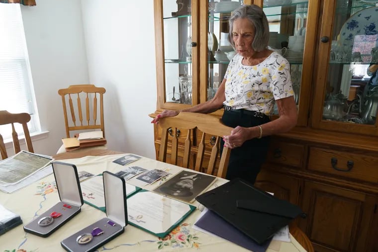 Marion Atkinson, 87, at home in Bensalem with photographs of her brother, US Army Staff  Sgt. Karl R. Loesche, After surviving the Bataan Death March, he died of dysentery in a Japanese POW camp in the Philippines in 1942. His recently identified remains will be brought home and interred with full military honors Nov. 17 at the Emanuel Lutheran Church cemetery in Elmer, NJ.