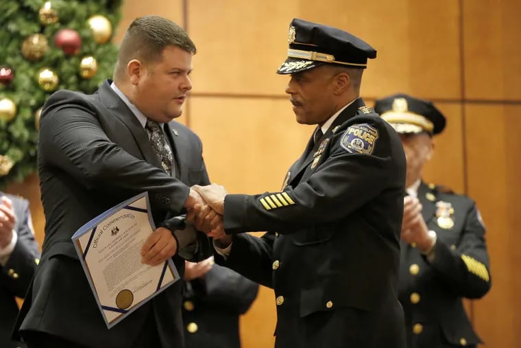 Philadelphia police officer Jessie Hartnett (left), is congratulated by commissioner Richard J Ross, Jr., after receiving the Sgt. Robert Wilson, III Valor Award during the Philadelphia Police Department Awards Ceremony at Fraternal Order of Police Lodge #5 on Wednesday.