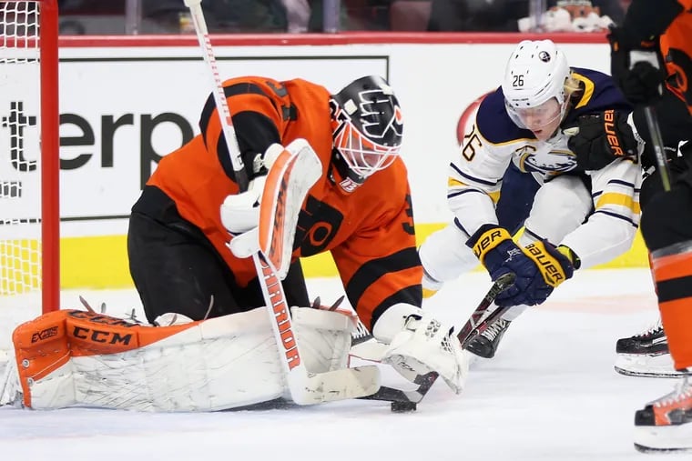Flyers' Brian Elliott (37) stops a shot by Buffalo Sabres' Rasmus Dahlin (26) during a game at the Wells Fargo Center in South  Philadelphia on Tuesday, Feb. 26, 2019.