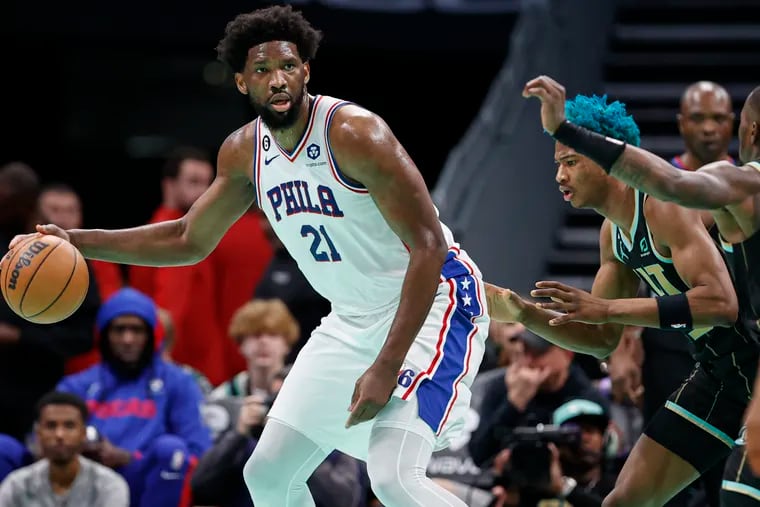 Sixers center Joel Embiid (21) looks to pass the ball as Hornets forward Kai Jones defends during the first half.