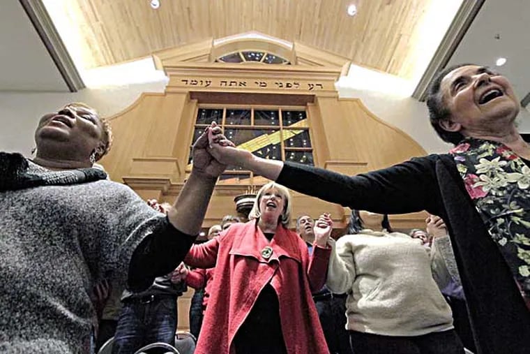(L-R) Connie Clary of Plainfield, NJ, Sharla Feldscher of Cherry Hill (2nd row center) and Marcy Partnow of Moorestown sing during Unity Choir rehearsal at Cherry Hill's M'kor Shalom temple on January 16, 2014. Blending the voices of Cherry Hill's M'kor Shalom temple and a number of African American Baptist congregations in SJ into the "Unity Choir," which has MLK Day-related performances scheduled. ( ELIZABETH ROBERTSON / Staff Photographer )
