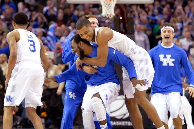 Kentucky players take to the court in celebration after edging Notre Dame on two foul shots with 6 seconds remaining.