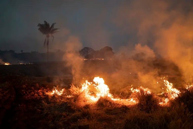 A fire burns a field on a farm in the Nova Santa Helena municipality, in the state of Mato Grosso, Brazil, on Friday. Under increasing international pressure to contain fires sweeping parts of the Amazon, Brazilian President Jair Bolsonaro authorized use of the military to battle the massive blazes.