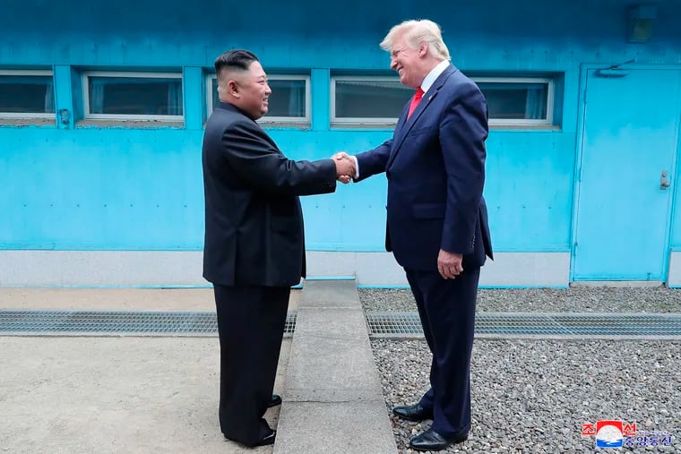 In this Sunday, June 30, 2019, photo provided by the North Korean government, North Korean leader Kim Jong Un, left, and U.S. President Donald Trump shake hands over the military demarcation line at the border village of Panmunjom in Demilitarized Zone. The content of this image is as provided and cannot be independently verified. Korean language watermark on image as provided by source reads: "KCNA" which is the abbreviation for Korean Central News Agency. (Korean Central News Agency/Korea News Service via AP)